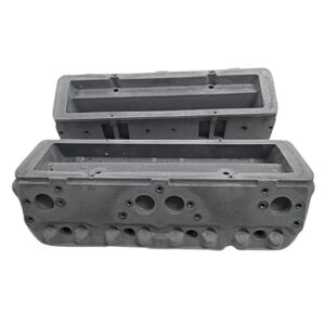 Two gray cylinder head blocks for engines